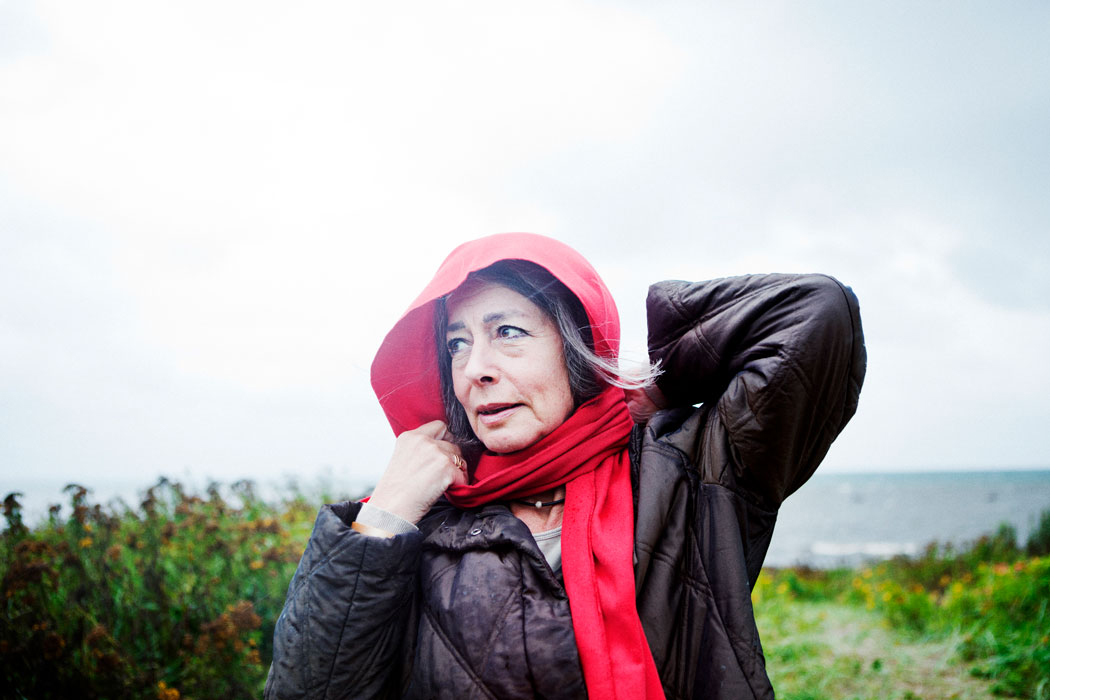 A woman with a red scarf on her head by the sea