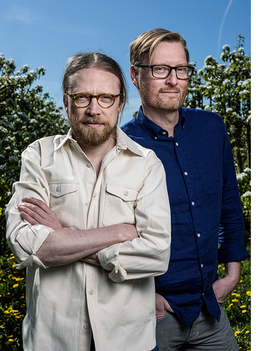 Two men poses outside 