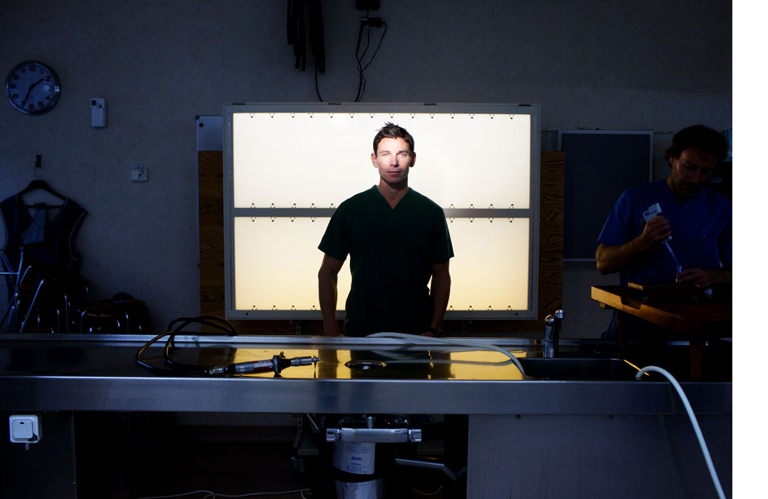 A younger man standing in a dark room